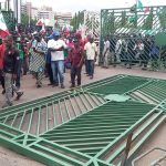 Entrance gate of National Assembly pulled down by Protesting workers,yesterday.