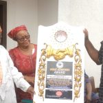 HRH Eze John Nwosu(left) flanked by wife being presented with merit award,recently.